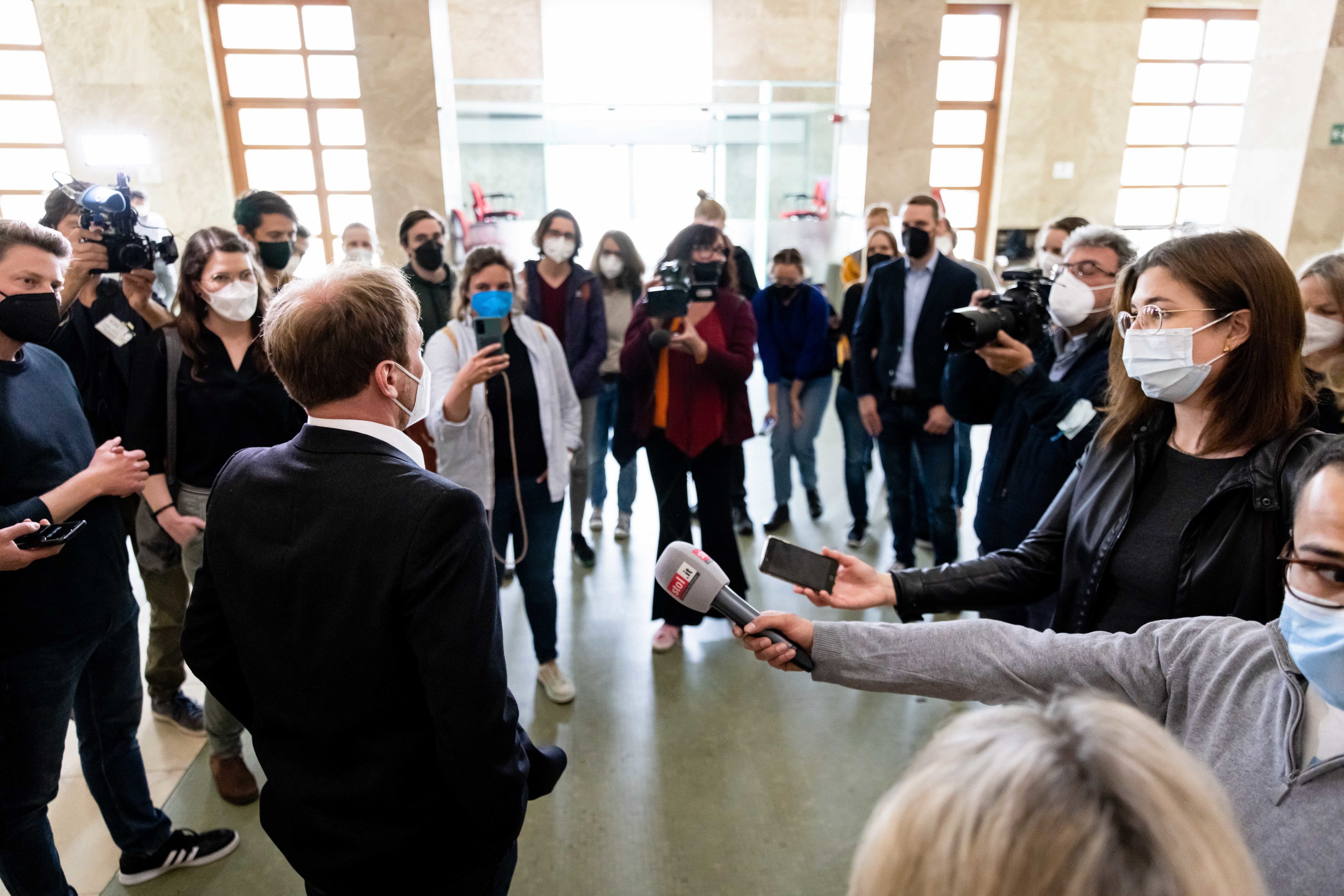 Der gerade freigesprochene Karl Bär spricht vor dem Gerichtssaal zu den Vertreter:innen von Presse und Medien