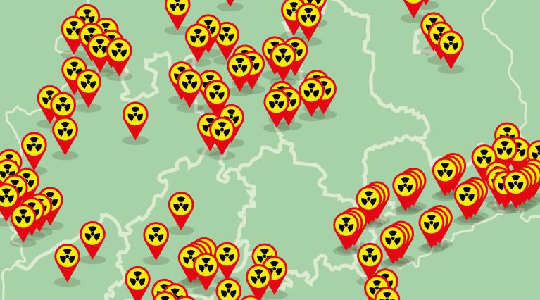 Landkarte (schematisch) mit roten Pins mit Radioaktivitäts-Warnzeichen