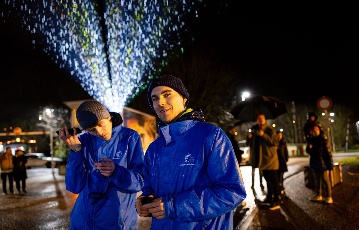 Kimateam des Umwetlinstitut vor der Projektion von Rissen und Spruch Ihr seid nicht ganz dicht auf Tanks der Solvay Chemiefabrik